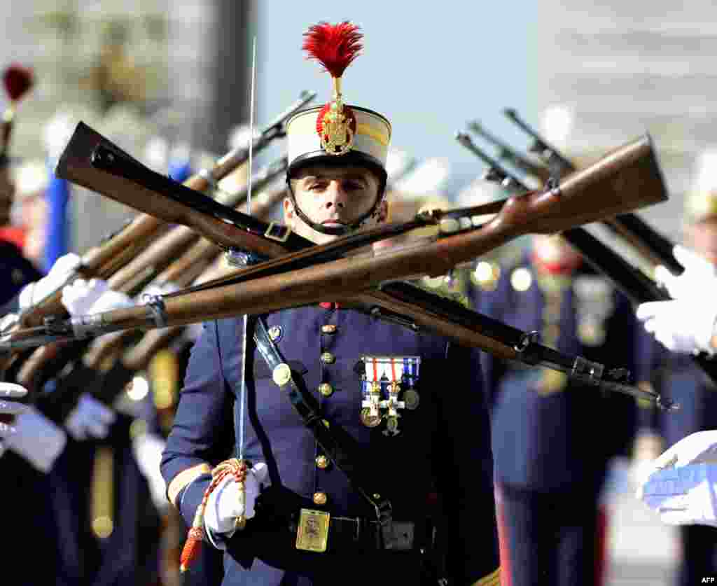 Members of the Spanish Royal Guard march during the monthly changing of the guard ceremony at the royal palace in Madrid.