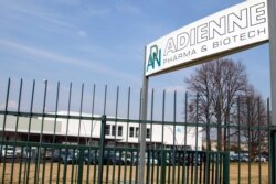FILE - Signage is seen at the plant of Italian-Swiss pharmaceutical company Adienne Pharma & Biotech, in Caponago, near Milan, Italy, March 9, 2021. Russia signed a deal with the company to produce millions of doses of its Sputnik vaccine this year.