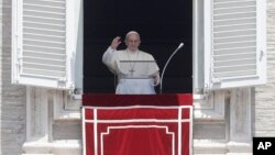 Pope Francis waves to faithful during the Angelus noon prayer in St. Peter's Square at the Vatican, June 3, 2018.