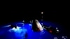 This image made from SpaceX video shows its capsule, center, carrying tech entrepreneur Jared Isaacman with his crew after it reached the Gulf of Mexico near Florida's Dry Tortugas, Sept. 15, 2024.