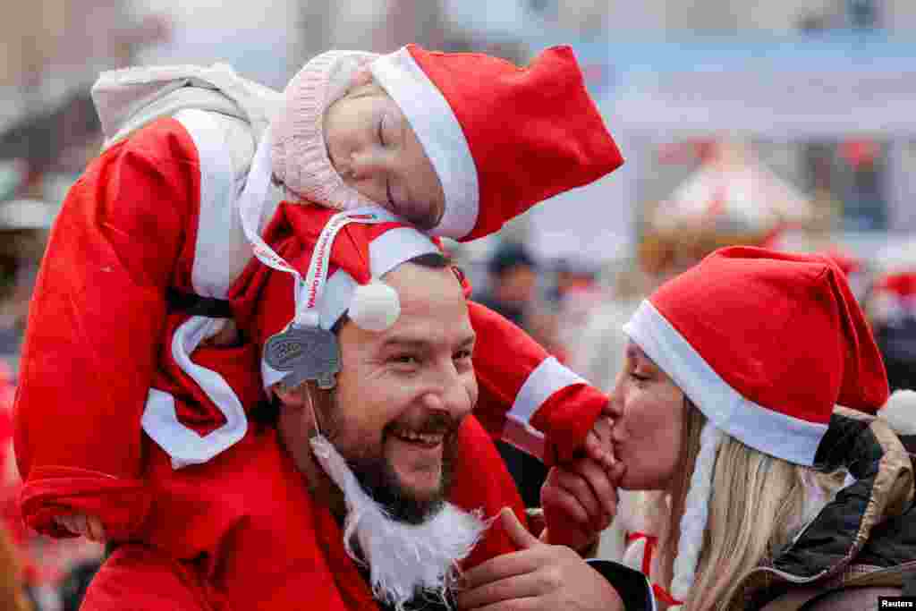 Participants wearing Santa Claus-themed outfits take part in a charity run, in Pristina, Kosovo.