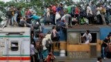 Bangladeshi Muslims try to climb on to the roof of an overcrowded train as they head to their homes ahead of Eid al-Fitr at a railway station in Dhaka.