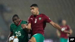 Morocco's Adam Masina, right, kicks the ball as he defends against Malawi's Stain Davie, during the African Cup of Nations 2022 round of 16 soccer match between Morocco and Malawi at the Ahmadou Ahidjo stadium in Yaounde, Cameroon, Jan. 25, 2022. 