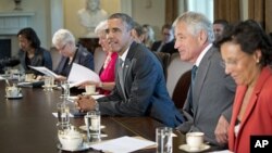 President Barack Obama awaits the start of a meeting with members of his cabinet, Sept. 12, 2013, in the Cabinet Room of the White House.