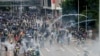 Police Fire Tear Gas as Large Crowds Defy Hong Kong Mask Ban