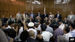 Egypt’s High Administrative Court judge Nazeh Tangho, center, reads decision on constitution in Cairo, Oct. 23, 2012.