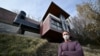 Architect Michael Kovac stands outside his house, which survived the Palisades Fire due to fire-resilient features used in its construction, in Los Angeles on Jan. 22, 2025.