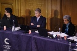 Members of the panel, from left, Ambreena Manji, Nick Vetch and Parveen Kumar listen as Chair of the panel Geoffrey Nice gives the opening address on the first day of hearings at the "Uyghur Tribunal" On June 4, 2021.