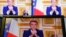 French President Emmanuel Macron is seen on monitors in a control room at AFP headquarters as he addresses the nation during a televised broadcast from the presidential Elysee Palace, on the day of the prime minister's resignation on Dec. 5, 2024.
