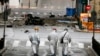 Forensic experts search for evidence on a street where a car bomb went off in Athens, April 10, 2014.
