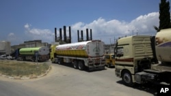 Egyptian trucks carrying fuel enter Gaza's power plant in the central Gaza Strip, June 21, 2017. Egypt on Wednesday trucked 1 million liters of cheap diesel to the Gaza Strip's sole power plant — a rare shipment that temporarily eased a crippling electric