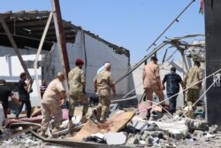 Officials examine a detention center after it was bombed in the war between Libya's competing governments in Tripoli, Libya, July 3, 2019. (Heather Murdock/VOA)