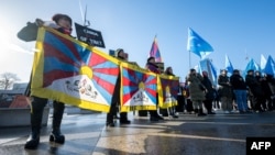 Tibetan and Uyghur activists stage a protest outside of the U.N. Offices at Geneva during the review of China's rights record by the United Nations Human Rights Council on Jan. 23, 2024.