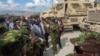 Kenya's President William Ruto, center-left, visits Kenyan police, part of a U.N.-backed multinational force deployed in Haiti to help curb gang violence in the country, at their base in Port-au-Prince, Haiti, Sept. 21, 2024. 