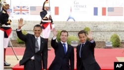 From left, US President Barack Obama, Russian President Dmitry Medvedev and French President Nicolas Sarkozy wave as they arrive for a lunch meeting at the Villa le Cercle during the G8 summit in Deauville, France, Thursday, May 26, 2011. G8 leaders, in a