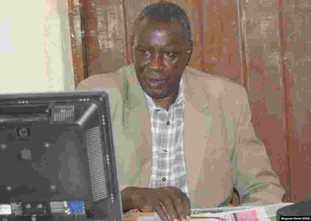 South Sudanese journalist Alfred Taban at his desk at The Juba Monitor. Taban says he was detained by police and is being sued by the former governor of Lakes state after publishing an editorial that was critical of him. (VOA/Mugume Davis)