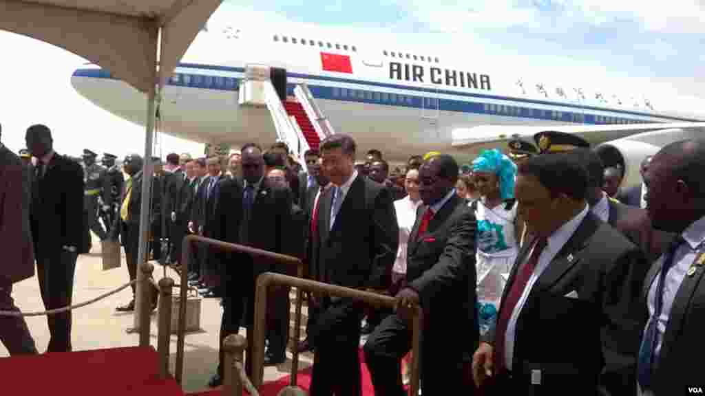 President Robert Mugabe and President Xi Jinping at Harare International Airport on Tuesday.