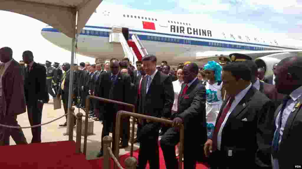 President Robert Mugabe and President Xi Jinping at Harare International Airport on Tuesday.