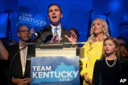 Kentucky Attorney General and democratic Gubernatorial Candidate Andy Beshear stands with his wife, Britainy as he delivers a speech at the Kentucky Democratic Party election night watch party, Nov. 5, 2019, in Louisville, Ky.