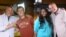 Larry London pictured with Scotty McCreery on the left, and Candice Glover on the right