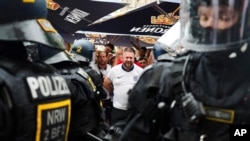 FILE -England fans speak with police officers as they celebrate ahead of a semi final match between Netherlands and England at the Euro 2024 soccer tournament in Dortmund, Germany, July 10, 2024. 