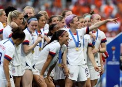 United States' Megan Rapinoe, center, celebrates team's victory with teammates after the Women's World Cup final soccer match between US and The Netherlands.