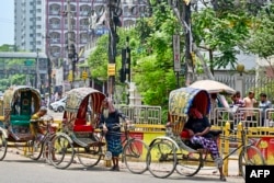 Rickshaw pullers rest amid a severe heatwave in Dhaka, Bangladesh, on April 25, 2024. Millions of pupils were told to stay home this week as the South Asian nation swelters through one of its worst heatwaves on record.