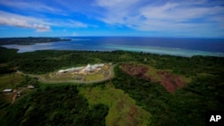 FILE — This June 20, 2009, photo features the Palau Capital building in Melekeok, Palau. The island nation of Palau made history this week when it became the first country to ratify last year's historic United Nations treaty for the protection of the Earth's oceans.  