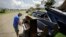 Wayne Christopher plays the keys on a piano put out on the curb in Port Arthur, Texas, Sept. 25, 2017, next to pews from the Memorial Baptist Church which he'd attended his whole life. 