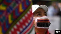 FILE - An indigenous woman takes part in a protest to demand the resignation of Guatemalan President Alejandro Giammattei, in Guatemala City, Nov. 24, 2020.