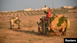 Turkish and U.S. troops are pictured during a joint patrol in Manbij area, northern Syria, Nov. 8, 2018.