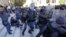 FILE - Police clash with protesters outside South Africa's Parliament in Cape Town, Oct. 21, 2015. Anti-riot police fired stun grenades to disperse scores of striking parliamentary workers demanding higher pay outside South Africa's assembly building.