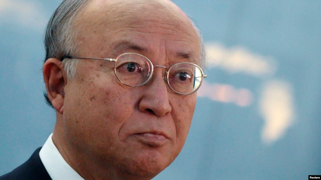International Atomic Energy Agency (IAEA) Director General Yukiya Amano talks to journalists after arriving at the Vienna International Airport in Schwechat, Nov. 12, 2013.
