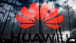 (FILES) In this file photo taken on November 6, 2019 the logo of Chinese telecom giant Huawei is pictured during the Web Summit in Lisbon. - The United States on November 18, 2019 granted another 90 days for companies to cease doing business with…