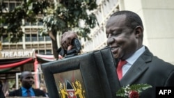 FILE - Kenya's Cabinet Secretary for National Treasury Henry Rotich leaves with the budget briefcase for Parliament to read the budget speech for 2018-2019 in Nairobi, Kenya, June 14, 2018.