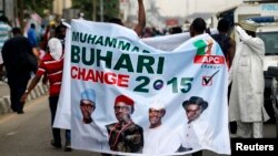 All Progressives Congress (APC) supporters hold a banner with a photograph of former military ruler Muhammadu Buhari in Lagos, Nigeria, Dec. 10, 2014.