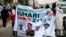 All Progressives Congress (APC) supporters hold a banner with a photograph of former military ruler Muhammadu Buhari in Lagos, Nigeria, Dec. 10, 2014.