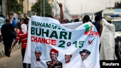 All Progressives Congress (APC) supporters hold a banner with a photograph of former military ruler Muhammadu Buhari in Lagos, Nigeria, Dec. 10, 2014.