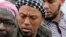 This photo taken on May 5, 2012, shows former German rapper Denis Cuspert, center, among salafi in Bonn, Germany.