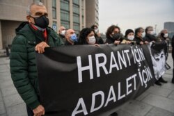 Demonstrators hold a banner reading "For Hrant, For Justice" during a gathering in front of the Caglayan Courthouse in Istanbul, March 26, 2021.