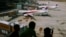 FILE - Children look at Malaysia Airlines Boeing 737-800 aircrafts parked at Kuala Lumpur International Airport, June 14, 2014.