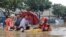 Rescue personnel evacuate residents from a flooded area following heavy rains caused by Typhoon Haikui in Xiamen, in China's southern Fujian province on Sept. 6, 2023. 