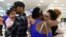 Waritza Alejandro embraces her mother-in-law Maritza Ortiz, before boarding a flight to Tampa with her husband Christian Vega and their daughter Tiana, in Carolina, Puerto Rico, Nov. 8, 2017. 
