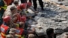 Pakistani Army troops and rescue workers struggle to recover a body in the rubble at the site of a suicide bombing in Shadi Khan, about 80 kilometers (50 miles) northwest from Pakistani capital, Aug. 16, 2015. 