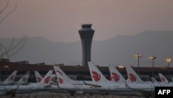 Air China planes are seen on the tarmac at Beijing Capital Airport in Beijing amid the ongoing COVID-19 coronavirus outbreak on March 13, 2020. - China reported just eight cases of the coronavirus on March 13, with no new domestic infections outside the e