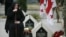 FILE - A woman mourns at the grave of a Georgian soldier killed during Georgia's conflict with Russia over the breakaway region of South Ossetia in 2008 during a ceremony at the memorial cemetery in Tbilisi, Georgia, Aug. 8, 2015. 