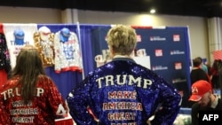 People wear merchandise in support of U.S. President Donald Trump at a vendor booth during the annual Conservative Political Action Conference at the Gaylord National Resort & Convention Center at National Harbor in Oxon Hill, Maryland, on Feb. 21, 2025.