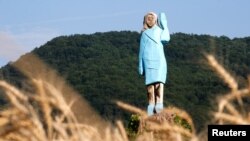 Life-size wooden sculpture of U.S. first lady Melania Trump is officially unveiled in Rozno, near her hometown of Sevnica, Slovenia, July 5, 2019.