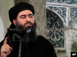 This file image made from video posted on a militant website July 5, 2014, purports to show Abu Bakr al-Baghdadi, delivering a sermon at a mosque in Iraq.