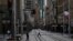 People in protective face masks walk through the quiet city center during a lockdown to curb the spread of COVID-19 outbreak in Sydney, Australia, July 28, 2021.
